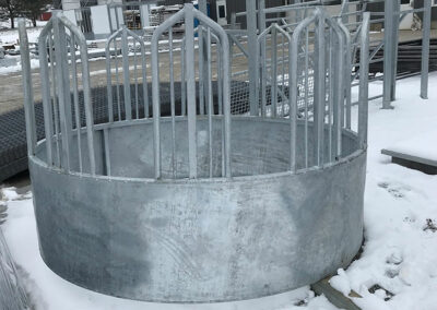 Metal bale feeder sitting in the snow