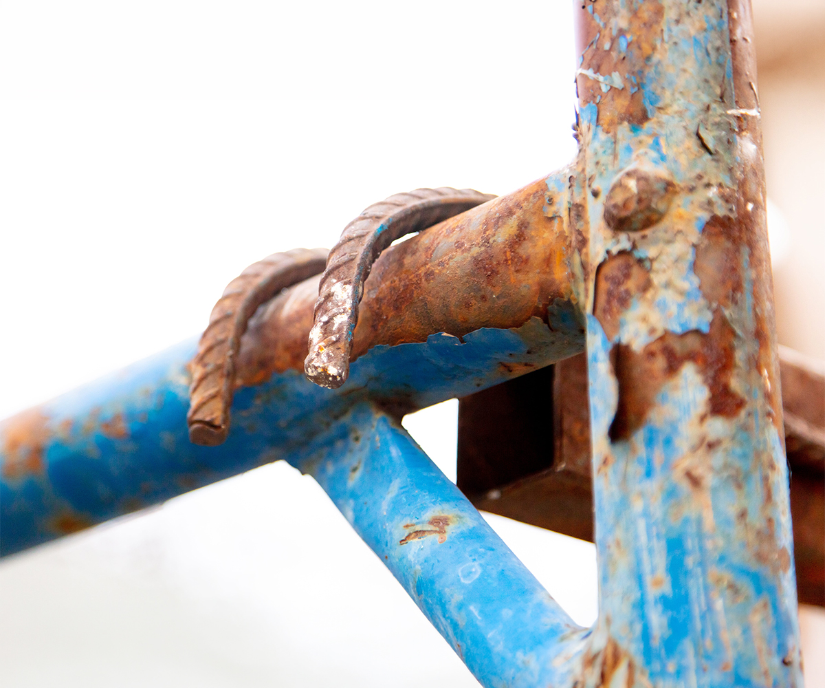 Rusted horse stall hardware showing corrosion damage in equine environments